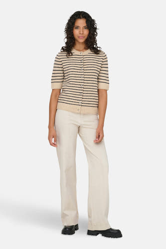 Ecru cardigan van ONLY® met zwarte strepen en een rij knopen, gecombineerd met ecrukleurige pantalon en zwarte schoenen.

