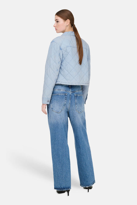 Veste en jean de couleur bleu clair de ONLY, avec un motif matelassé à carreaux, combinée avec un jean ample et des talons noirs.