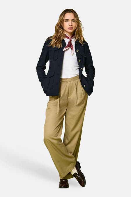 Pantalon beige de ONLY®, avec des jambes larges et une ceinture lâche, combiné à un blazer, un chemisier blanc et une écharpe rouge.