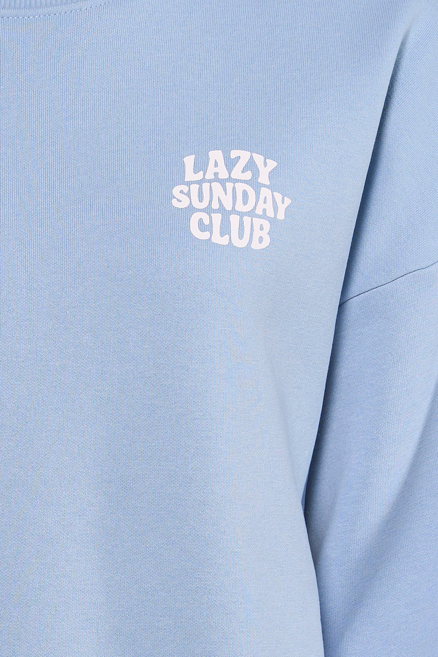 Pull bleu de ONLY® avec l'inscription "Lazy Sunday Club" imprimée dessus.