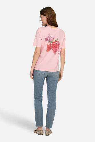 T-shirt à manches courtes rose de ONLY, avec un imprimé de fraises et le texte "A Berry Good Time". Porté avec un jean et des chaussures en cuir de serpent.