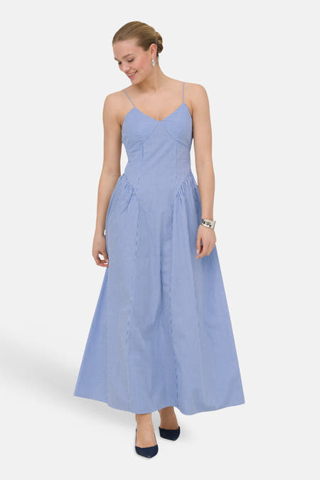 Robe longue bleue à rayures sans manches de ONLY® avec col en V et plis, portée avec des bijoux argentés.