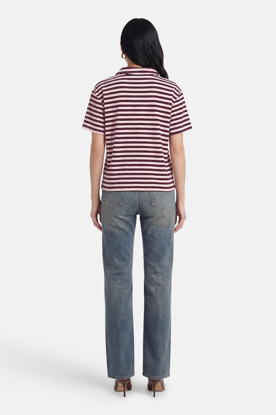 Polo rayée à manches courtes de JDY en rose et bordeaux, portée avec un jean et des talons marron, vue de dos.