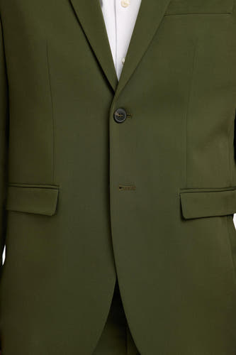 Blazer vert de SELECTED, avec une fermeture à un seul bouton et des poches passepoilées.