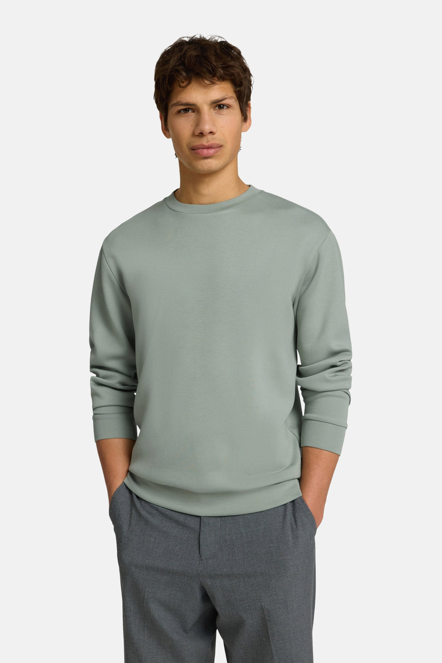 Pull vert à col rond de SELECTED, à manches longues et poignets côtelés, porté par un homme.