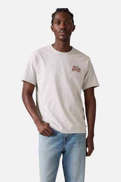 T-shirt gris à manches courtes de Levi's®, avec un petit logo sur la poitrine et associé à une pantalon en denim.