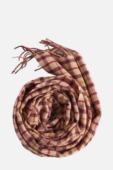 Multikleurige wintersjaal van MANGO, gerold in een spiraalvormig patroon met bruine en rode accenten en franjes.
