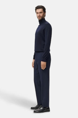 T-shirt bleu avec col rond de MANGO, porté avec un pantalon foncé et des chaussures noires, dans une photo latérale.