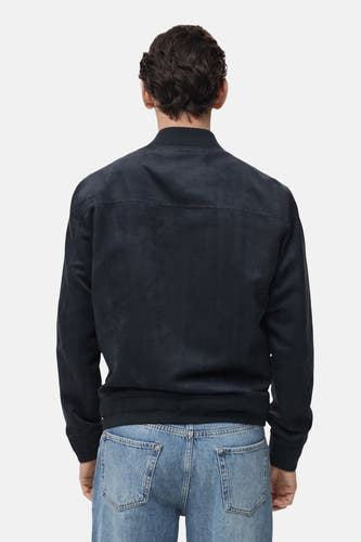 Manteau court bleu de MANGO, vu du dos arrièreéé avec un jeans bleu.