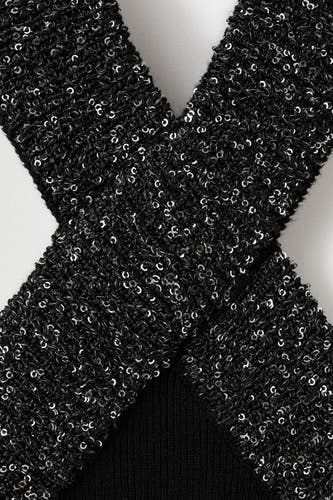 Blouse no manches noire MANGOANGO un design croé et des paillettes brillantes.
