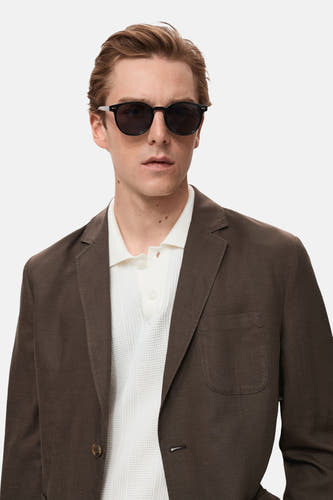 Blazer marron de MANGO, avec col revers et fermeture à un seul bouton, porté sur un t-shirt blanc.
