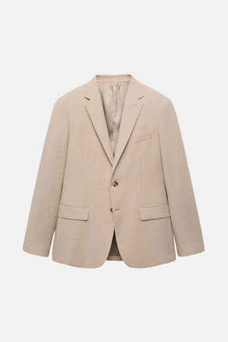 Blazer beige de MANGO, avec fermeture à boutons et poches.