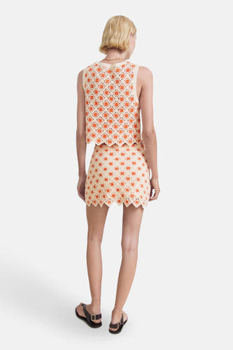 Short multicolored skirt from MANGO, with a crocheted flower pattern and a decorative sculpted edge.