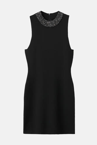 Robe sans manches noire de MANGO, avec une ligne d'encolure ronde terminée par des paillettes argentées.