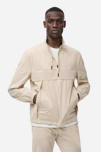 Manteau court beige de MANGO, avec fermeture à glissière et poches.