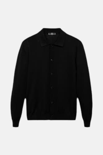 Veste noire de MANGO, avec fermeture à boutons et longues manches.