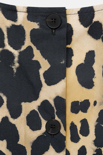 Blouse sans manches beige de MANGO avec imprimé animal et détails de nœuds.