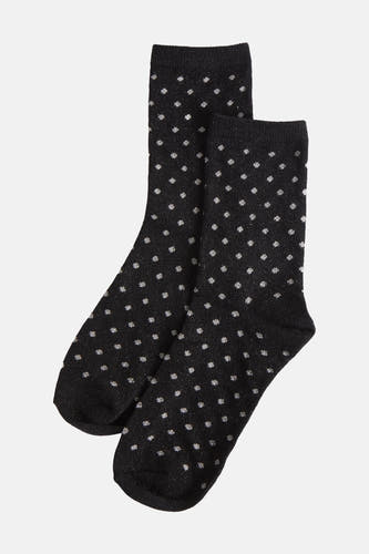 Chaussettes noires de PIECES® avec un motif à points argentés et une texture brillante.