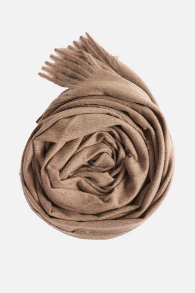 Beige wintersjaal van MANGO, opgerold en met franjes aan één uiteinde.