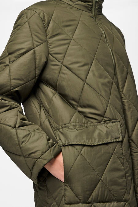 Veste verte de PIECES® avec un motif à carreaux et une poche po boutonnée, gros plan.