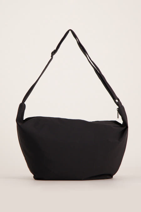 Sac à dos noir de Pieces, avec une s réable et un fermeture éclair sur le dessus.