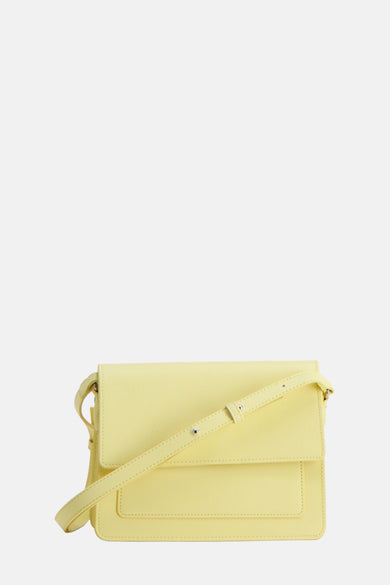 Sac à dos bleu de PIECES avec une sangle d'épaule ajustable et une fermeture éclair magnétique.