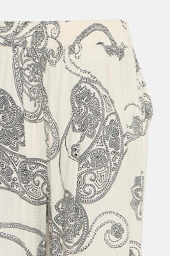 Pantalon écru de France, avec imprimé paisley et une ceinture élastique, en coupe cropped côté.