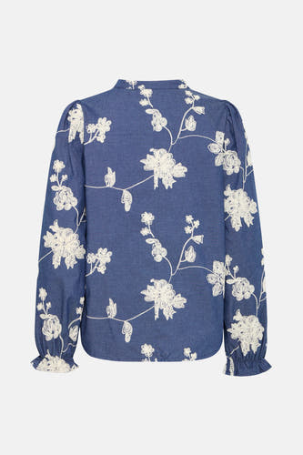 Blouse bleue à longues manches en Fransa, avec motif floral et volants aux extrémités des manches.