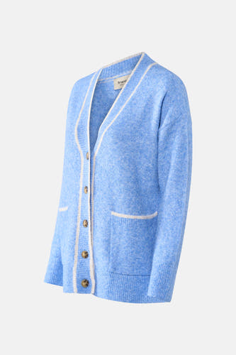 Veste bleue de France, avec une cravate blanche, des manches longues et un col boutonné, y compris des poches brodées.