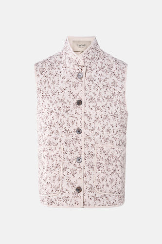 Gilet écru de France avec des motifs floraux bruns et une fermeture à boutons devant.