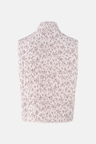 Gilet en écru, de France, avec un motif de fleurs brunes et des détails brodés sur l'arrière.