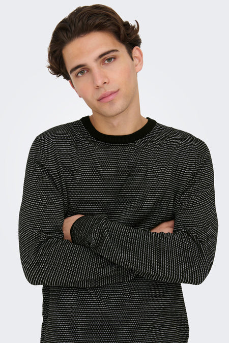 Pull noir à col rond de ONLY & SONS® avec fines rayures blanches, porté par un mannequin aux bras croisés, vue de face