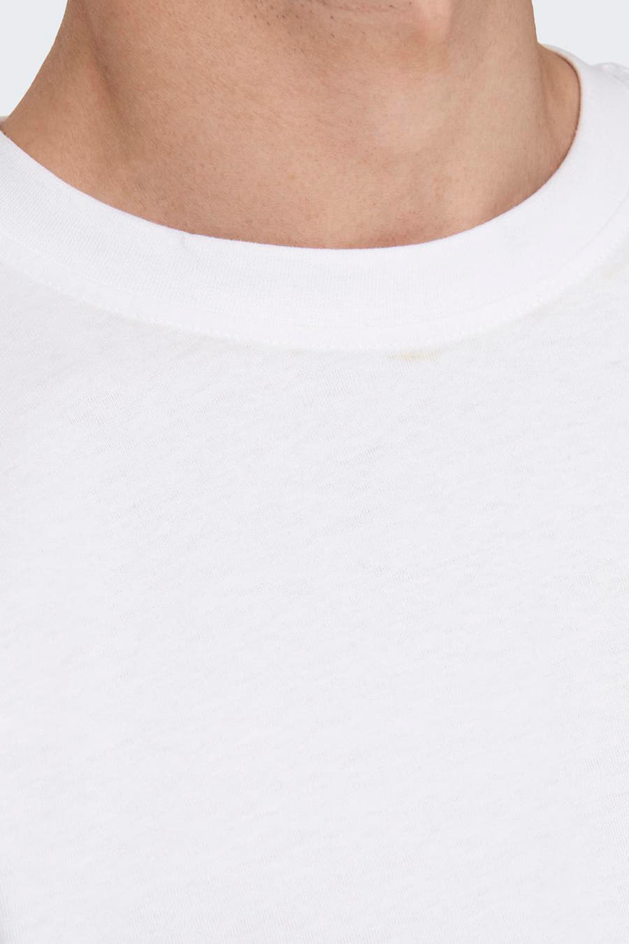 T-shirt blanc de ONLY & SONS®, porté avec un pantalon gris à carreaux et un bracelet rouge.