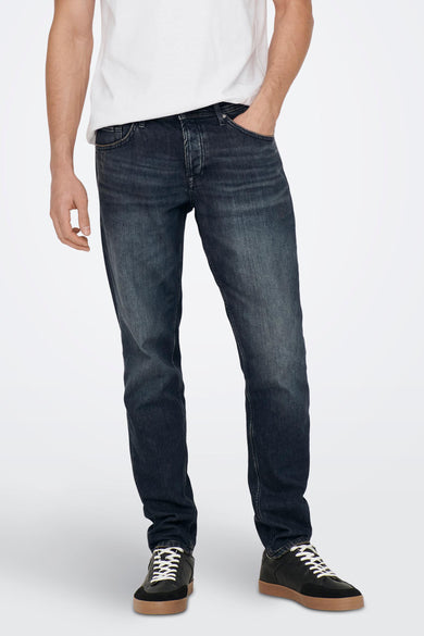 Jean tapered en denim gris foncé de ONLY & SONS, avec un lavage subtil et des baskets en cuir noir.