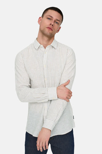 Chemise rayée beige à longues manches de ONLY & SONS, avec des bras croisés et un jeans bleu.