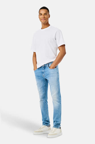Jean droit bleu clair d'ONLY & SONS®, porté avec un T-shirt blanc et des baskets crème.