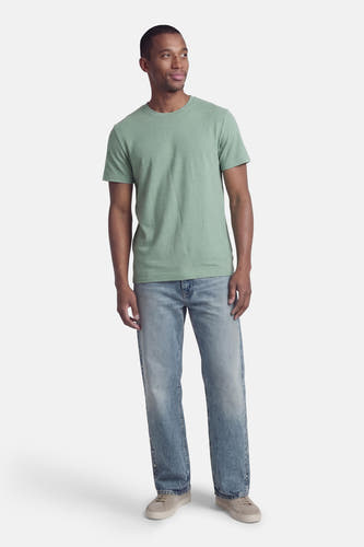 T-shirt vert à manches courtes ONLY & SONS®, porté avec un jean bleu et des chaussures grises.