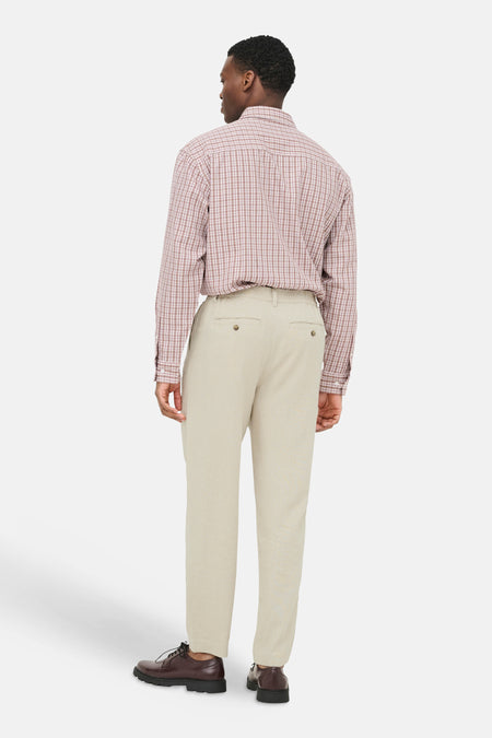 Pantalon beige de ONLY & SONS® en tissu légèrement texturé, avec taille élastique et poches à boutons, vue de dos d'un homme.