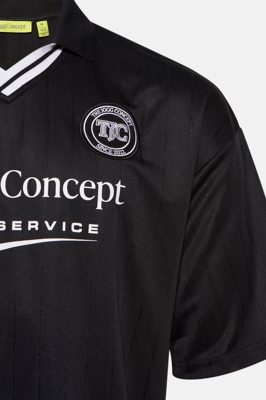 T-shirt noir à manches courtes de THEJOGGCONCEPT, avec logo sur la poitrine et rayures verticales.