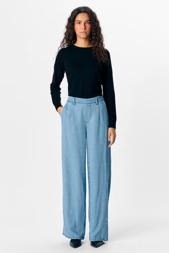 Lichtblauwe denim broek van OBJECT, met wijde pijpen en gecombineerd met een zwarte trui.