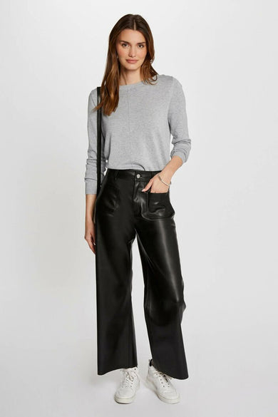 Pantalon noir de Morgan De Toi, avec des poches larges et des poches à rabat, associé à une chemise grise et des baskets blanches.