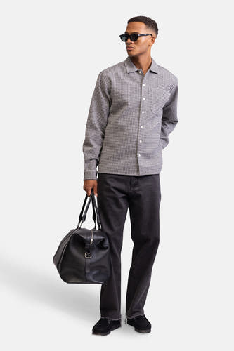 Chemise grise à manches longues de REDEFINED REBEL, avec un fin motif géométrique, portée avec un pantalon noir et une sacoche.
