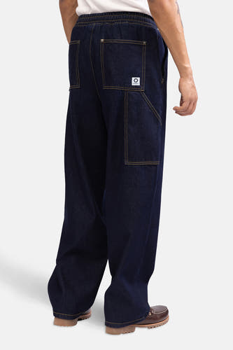 Jean délavé bleu marine de REDEFINED REBEL, avec des surpiqures jaunes et une ceinture élastique.