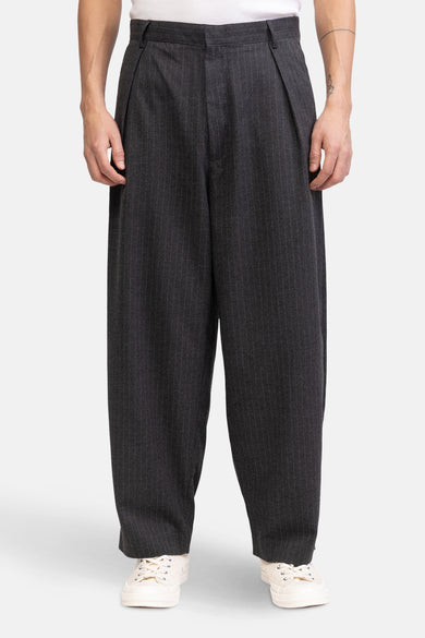 Pantalon gris de REDEFINED REBEL avec motif à rayures blanches, décontracté et associé à des baskets blanches.