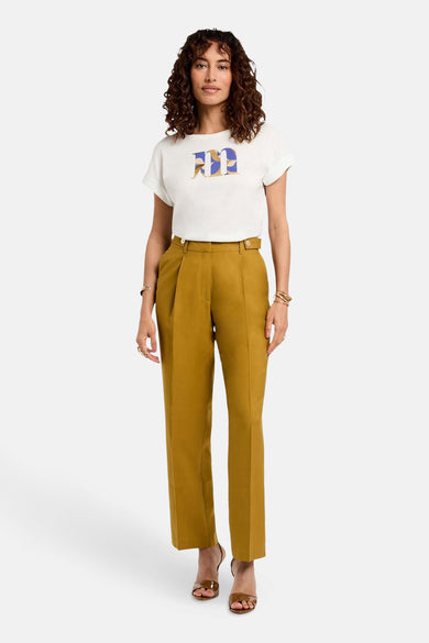 T-shirt blanc à manches courtes de Morgan De Toi, associé à un pantalon beige et des baskets brunes.