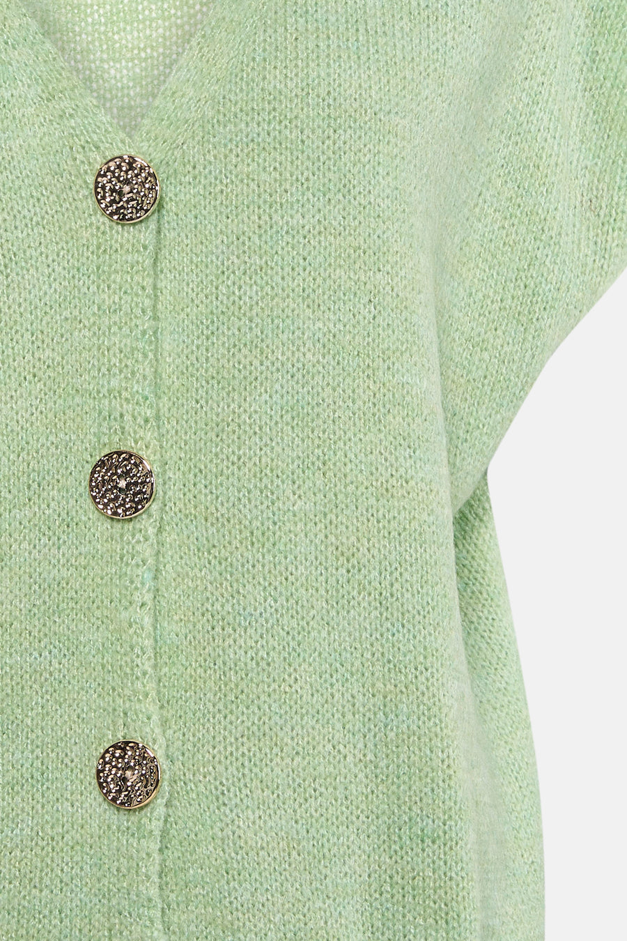 Gilet vert de Terra di Siena de couleur verte avec des boutons dorés décoratifs et une texture tricotée.
