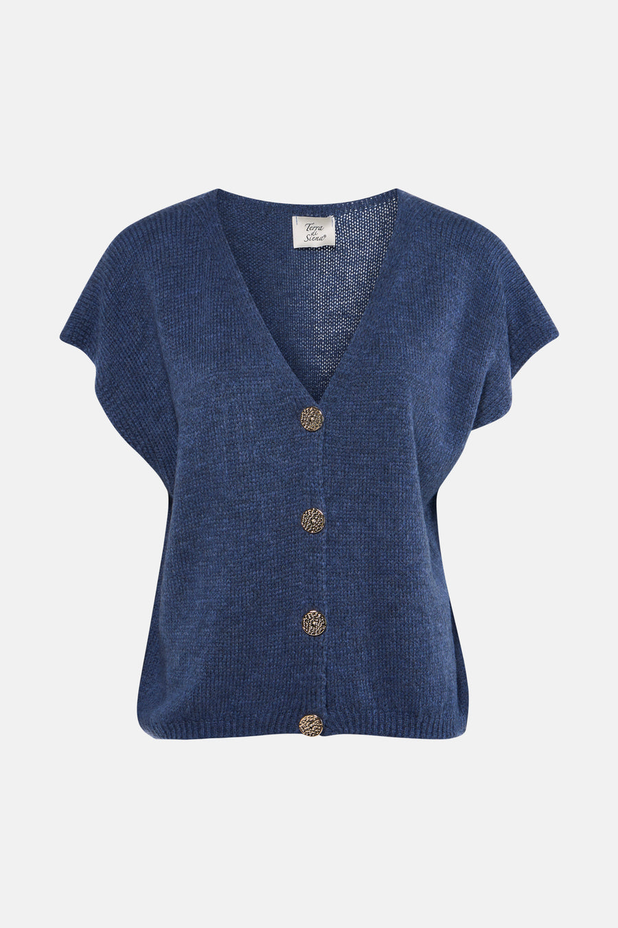 Gilet bleu de Terra di Siena, avec fermeture à boutons, porté sur un jean foncé et des chaussures noires.