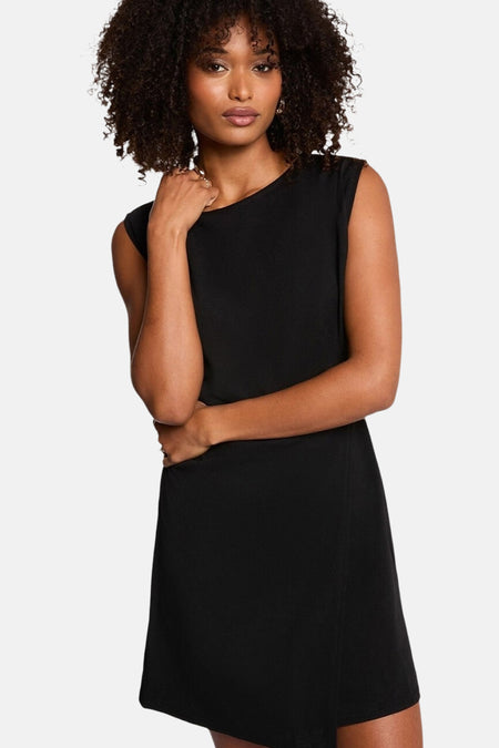 Vrouw in zwarte jurk met krullend haar.