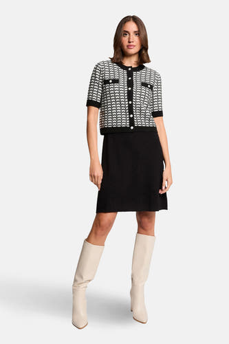 Robe noire à manches courtes de Morgan De Toi, avec un blouson rayé blanc et noir à des boutons dorés.