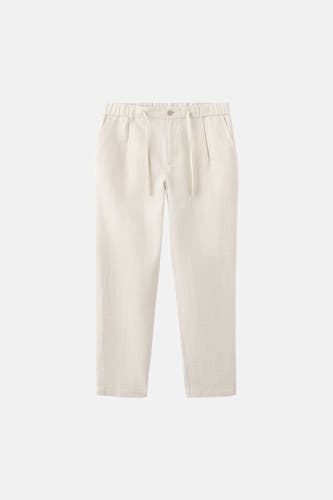 Pantalon écru de MANGO avec une taille élastique et un cordon de serrage.